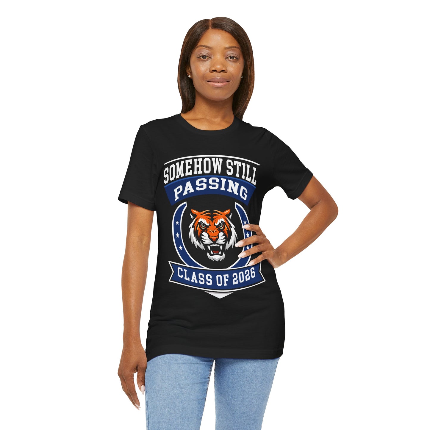 Somehow Still Passing — Funny Senior Tiger Tee (Class of 2026)